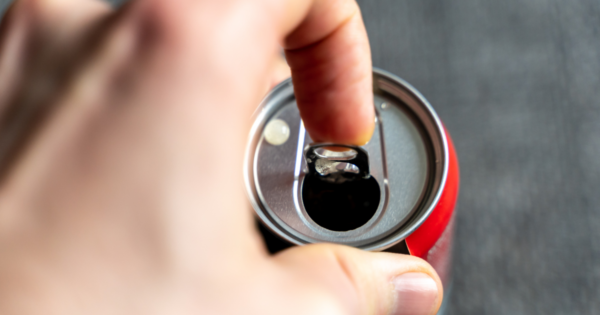 Person opening a beverage can