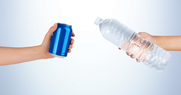 Two hands holding an aluminum can and a plastic beverage bottle