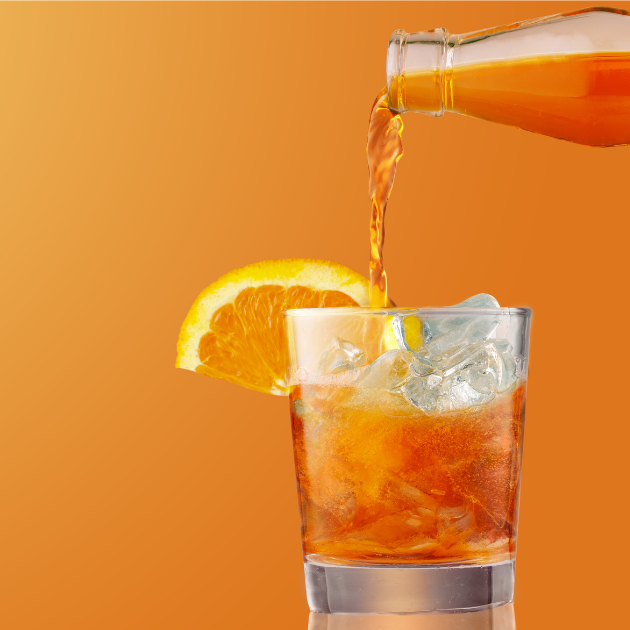 Cocktail beverage bring poured from a bottle into a drinking glass