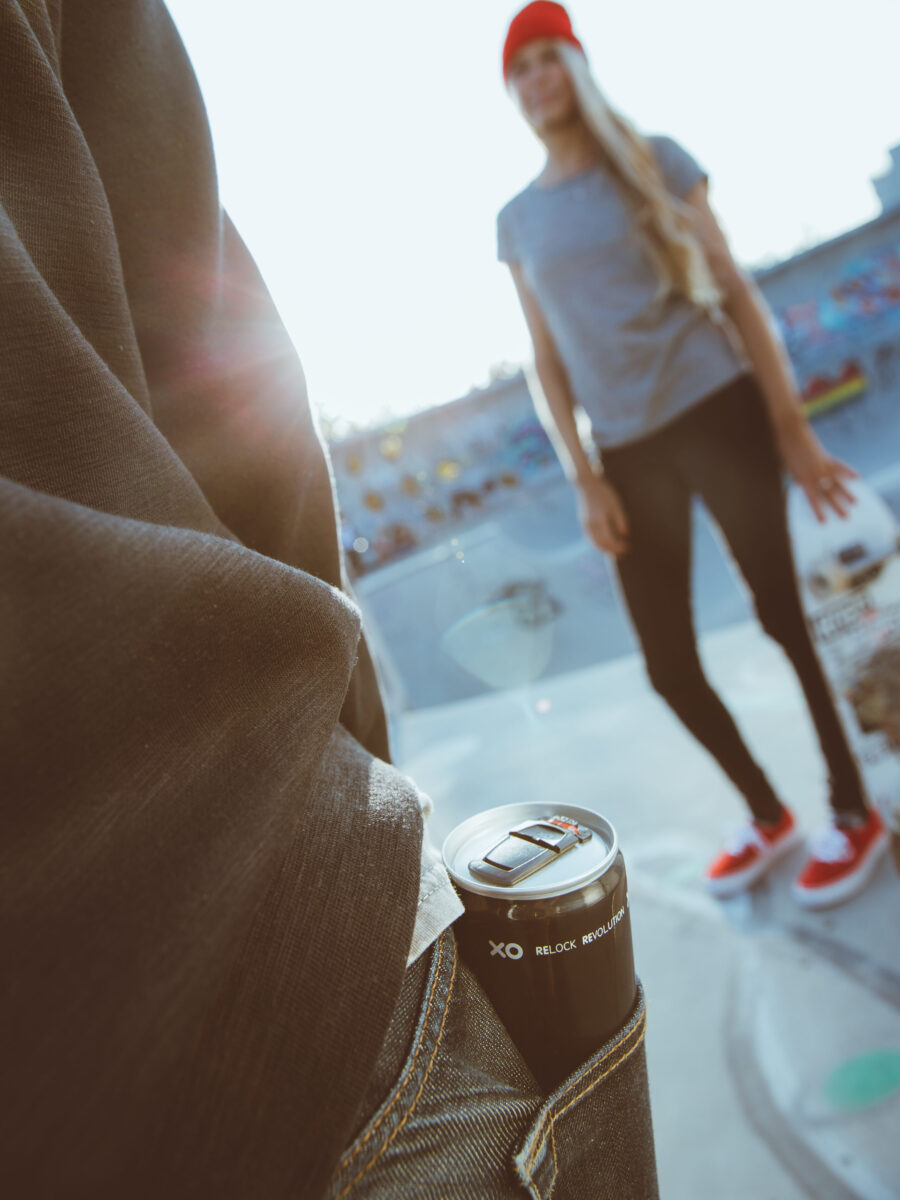 Person with beverage can in their back pocket