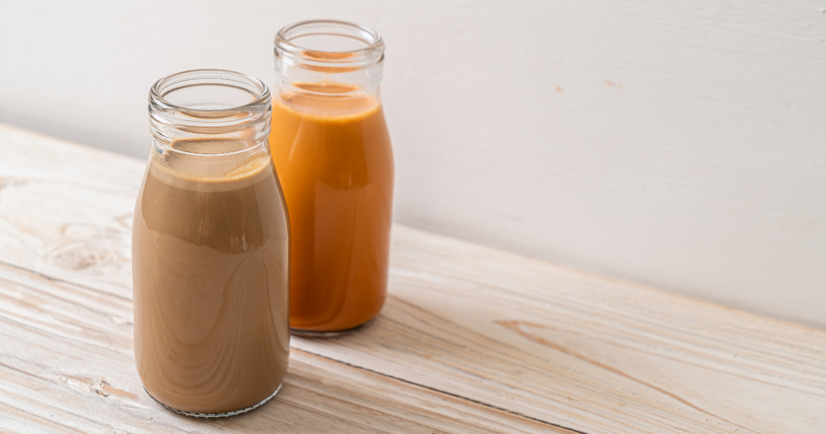 Two coffee and juice beverages in glass bottles