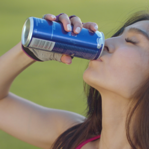 Woman drinking from beverage can